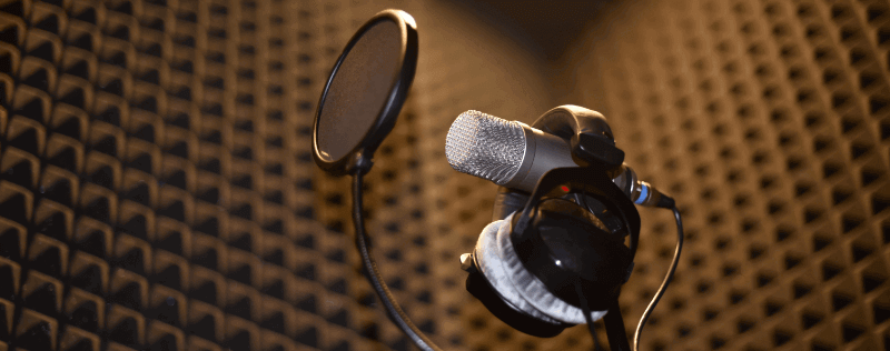 a microphone in a soundproof music studio